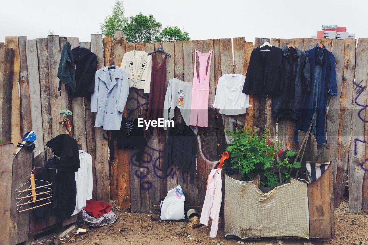 Clothes drying on wooden wall