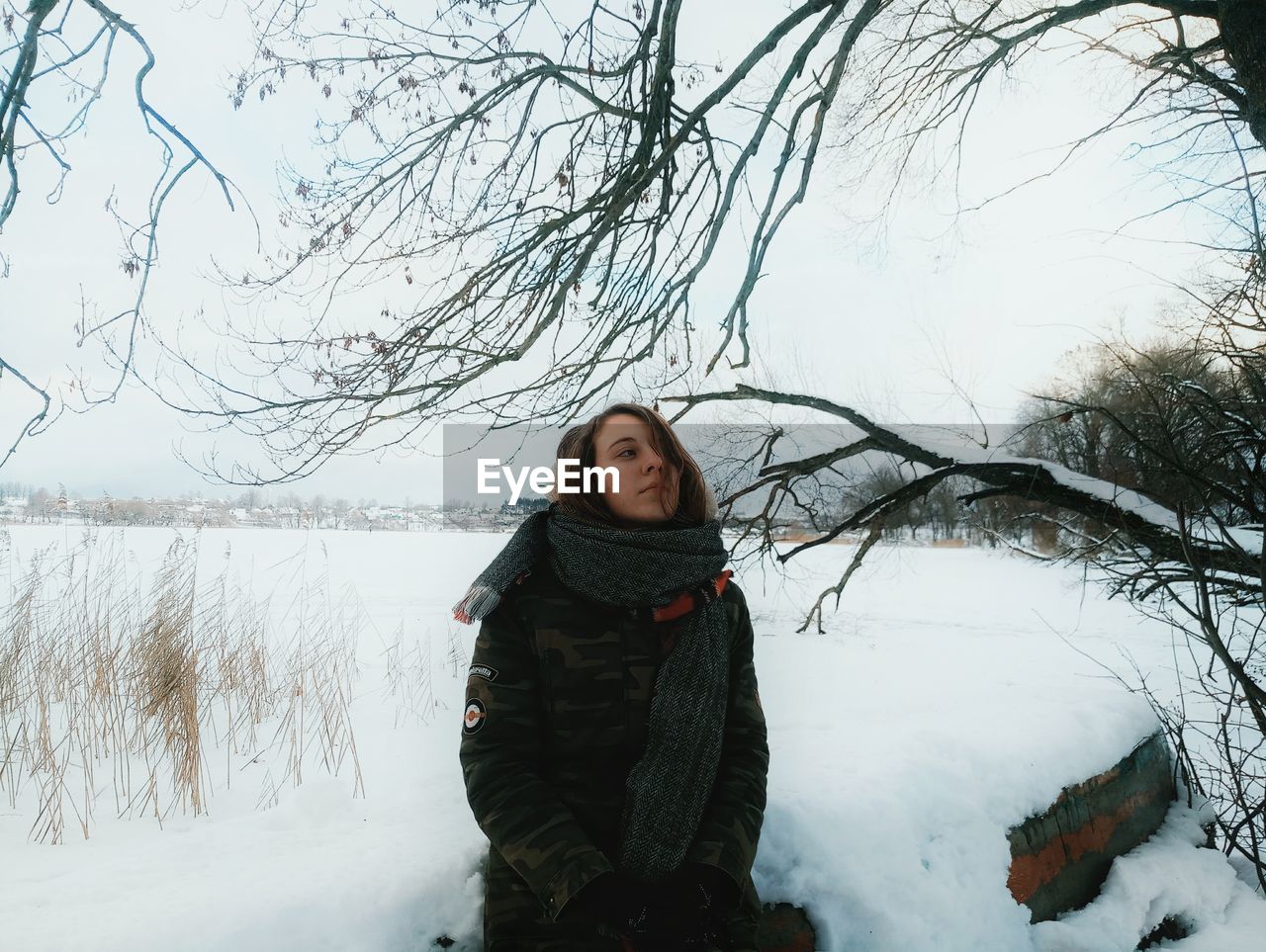 FULL LENGTH OF WOMAN IN SNOW AGAINST SKY