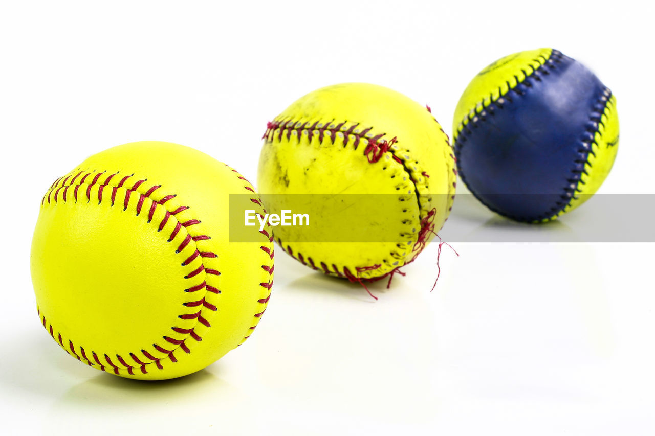 Close-up of baseball balls against white background