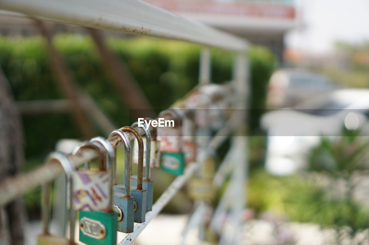 Close-up of chain hanging on railing