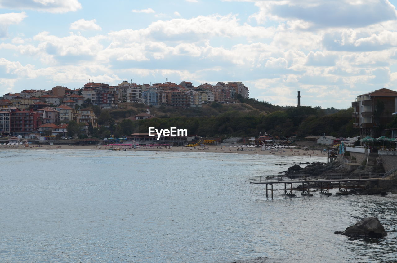 TOWN AGAINST CLOUDY SKY