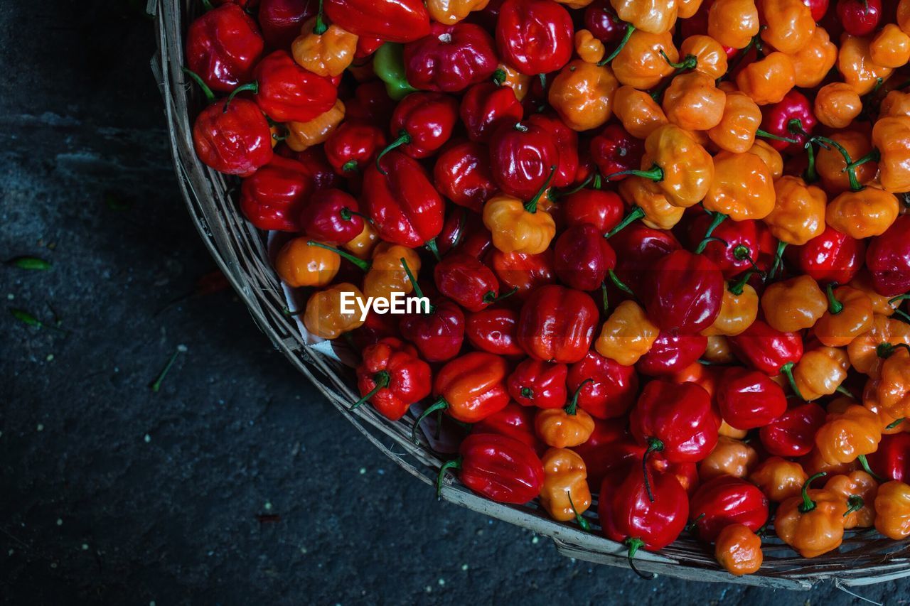 High angle view of bell peppers in basket for sale