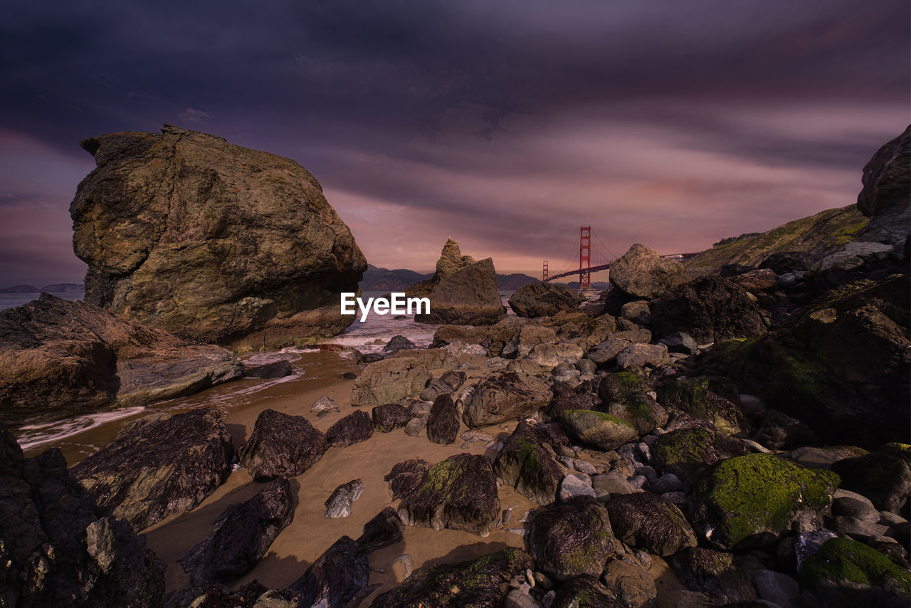 Low angle view of rocks against sky during sunset