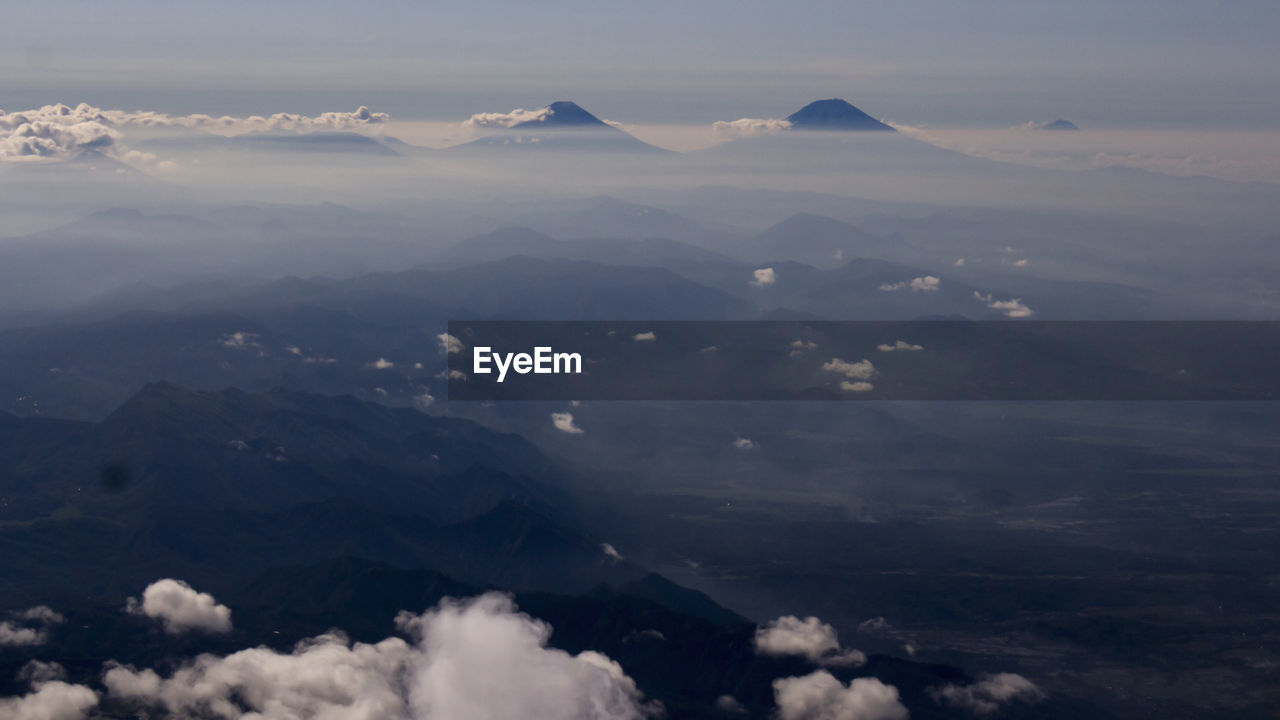 Aerial view of mountains against sky during foggy weather