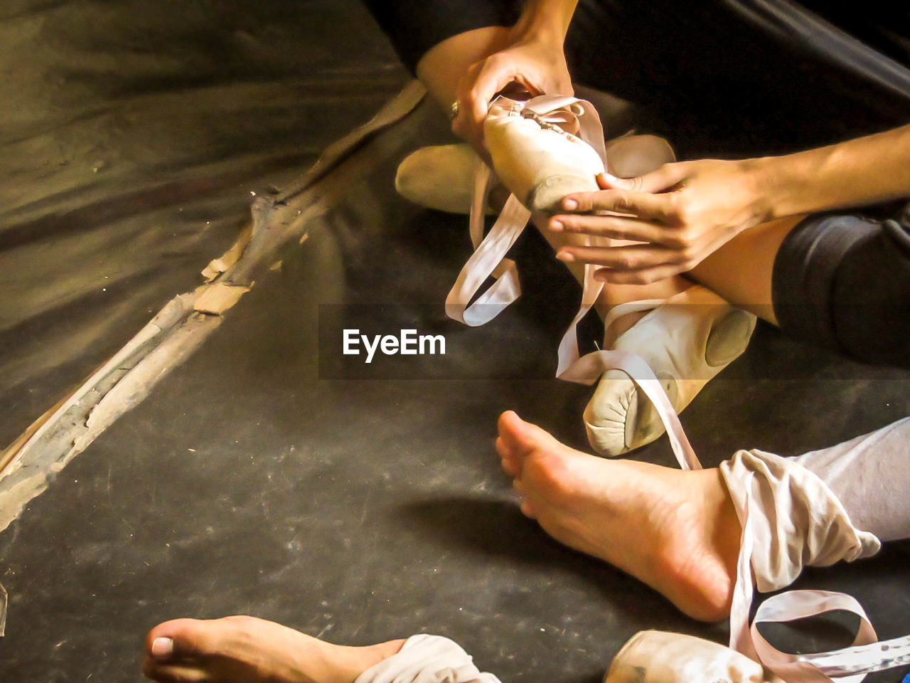 Low section of woman wearing ballet shoes