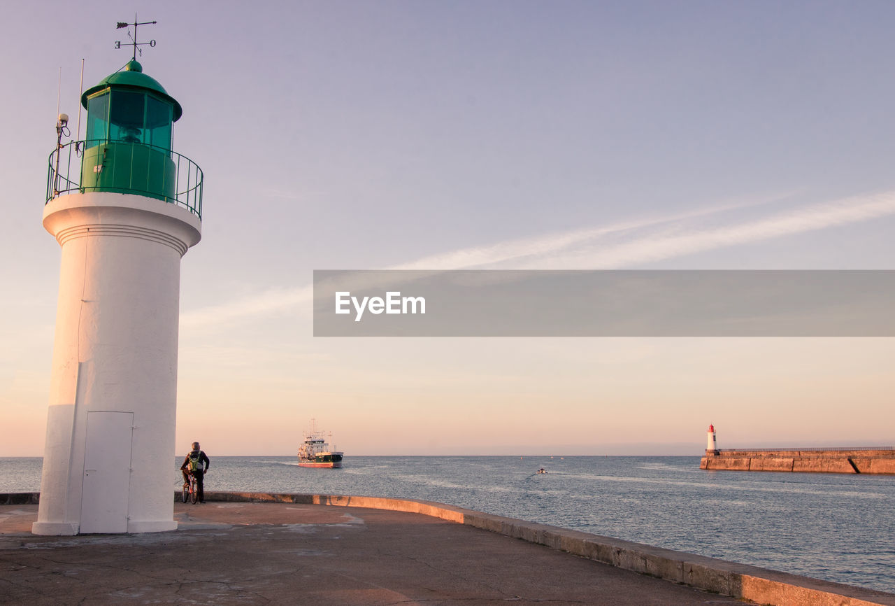 The little jetty or the skippers' jetty and the green lighthouse at les sables d'olonnes in summer