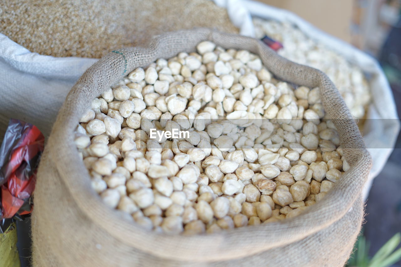 Sack of candlenut at indonesian traditional vegetable market