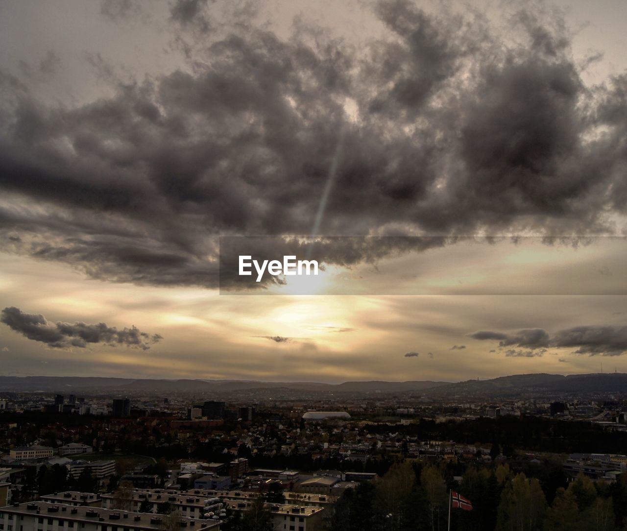 Cityscape against cloudy sky