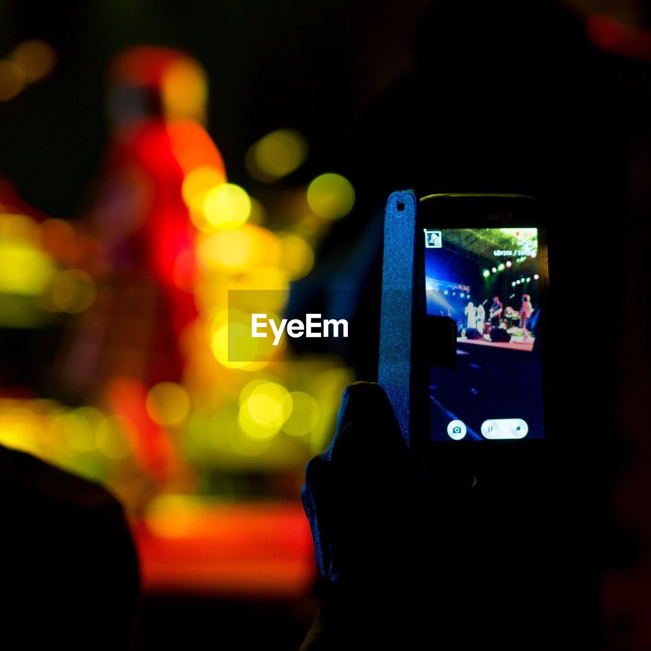 Close-up of hand using mobile phone at night