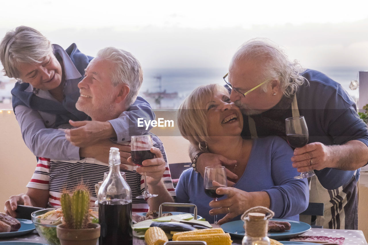 Happy senior couples at dining table