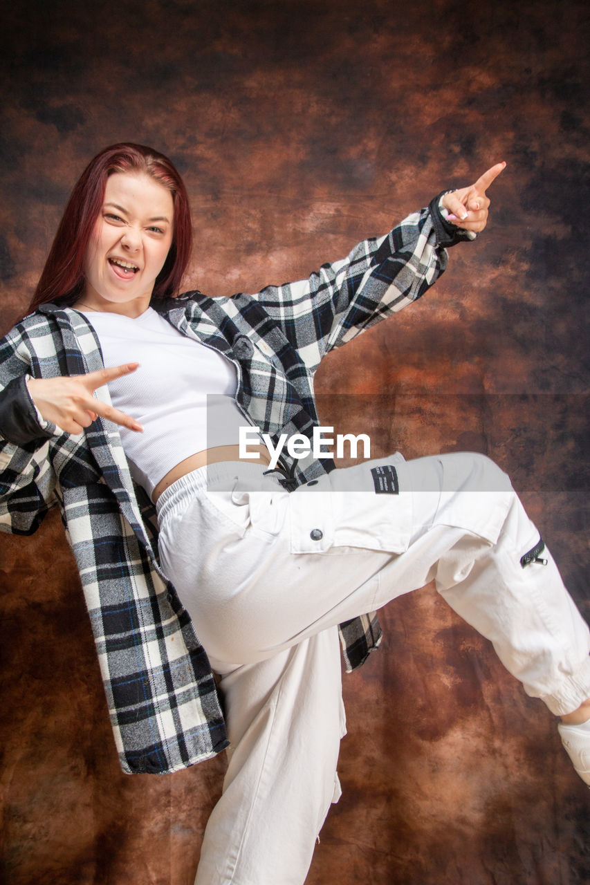 adult, one person, young adult, women, emotion, clothing, happiness, smiling, portrait, indoors, activity, female, dancing, person, photo shoot, lifestyles, white, fun, cheerful, studio shot, casual clothing, child