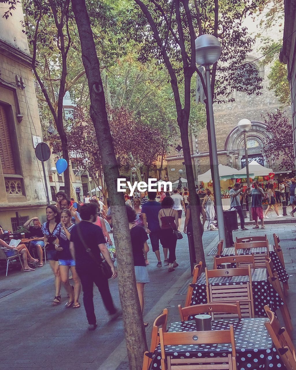 LOW ANGLE VIEW OF PEOPLE WALKING ON STREET