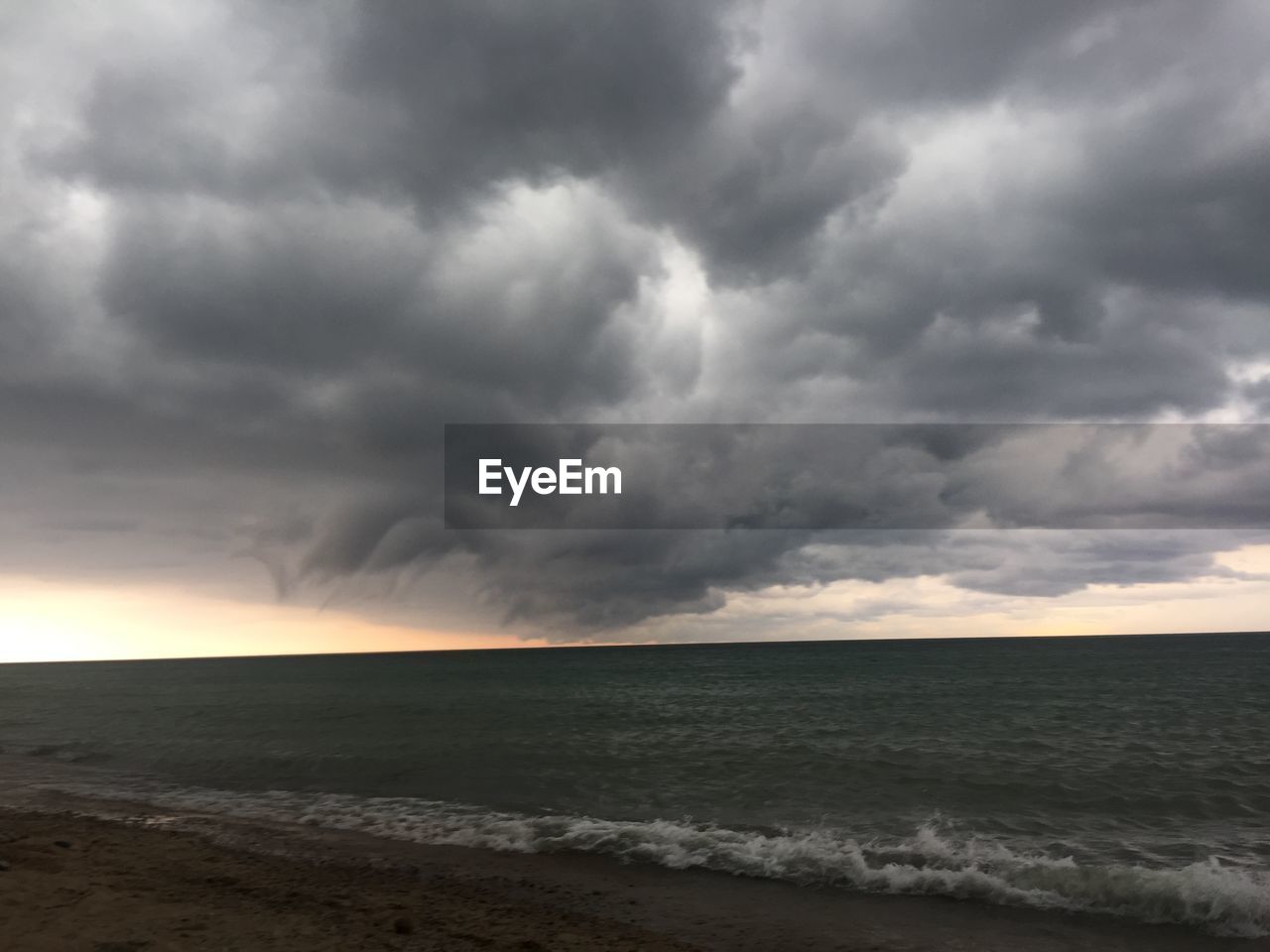 VIEW OF SEA AGAINST CLOUDY SKY