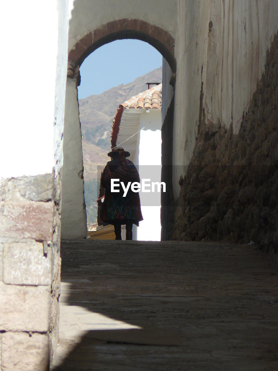 REAR VIEW OF MAN LOOKING UP