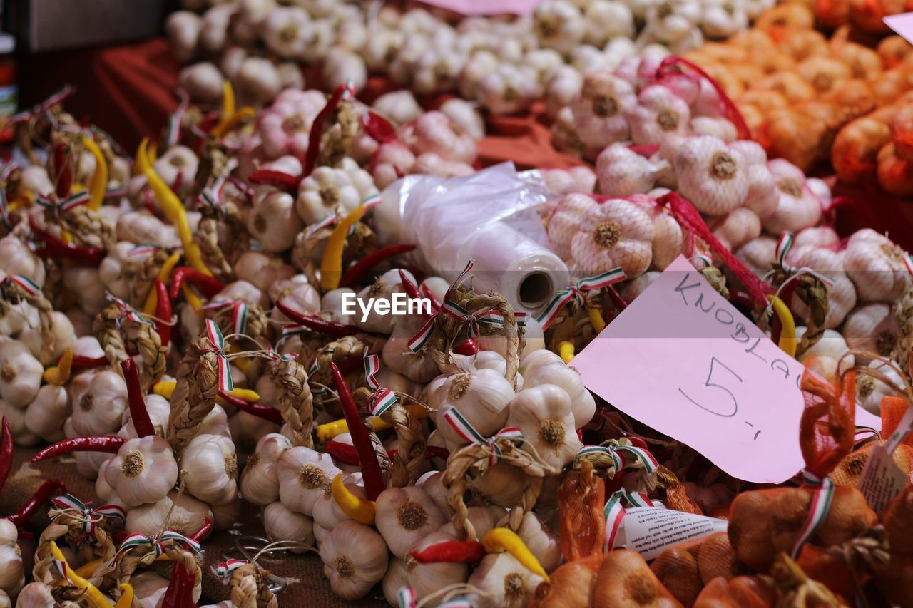 High angle view of fresh garlic cloves with label at market stall