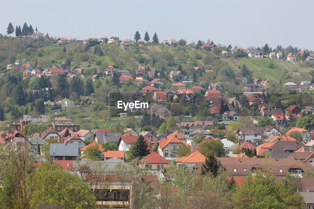 High angle view of houses in town against clear sky