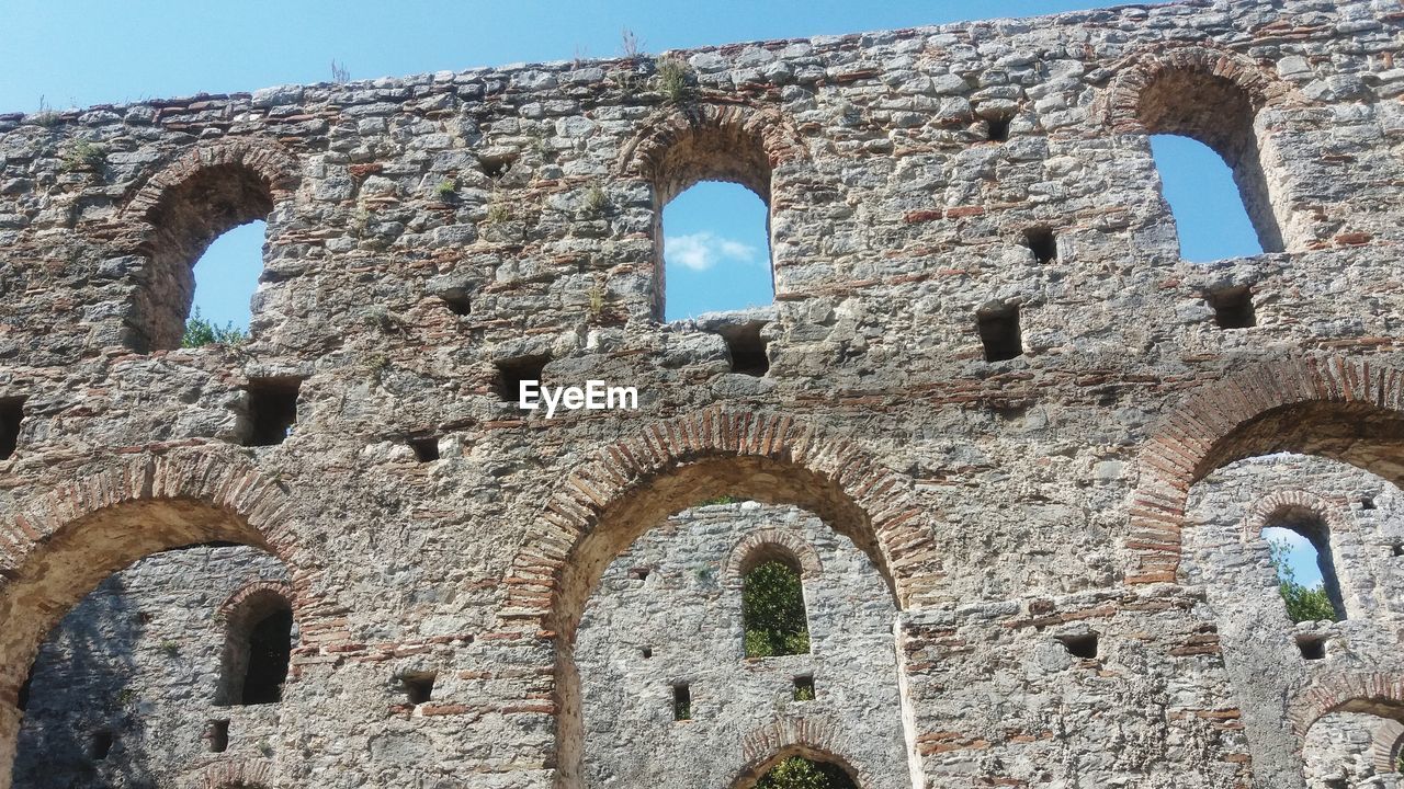 Low angle view of old ruins against sky