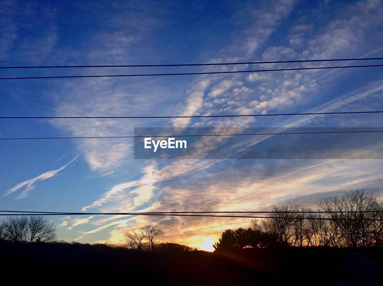 ELECTRICITY PYLON AGAINST SKY