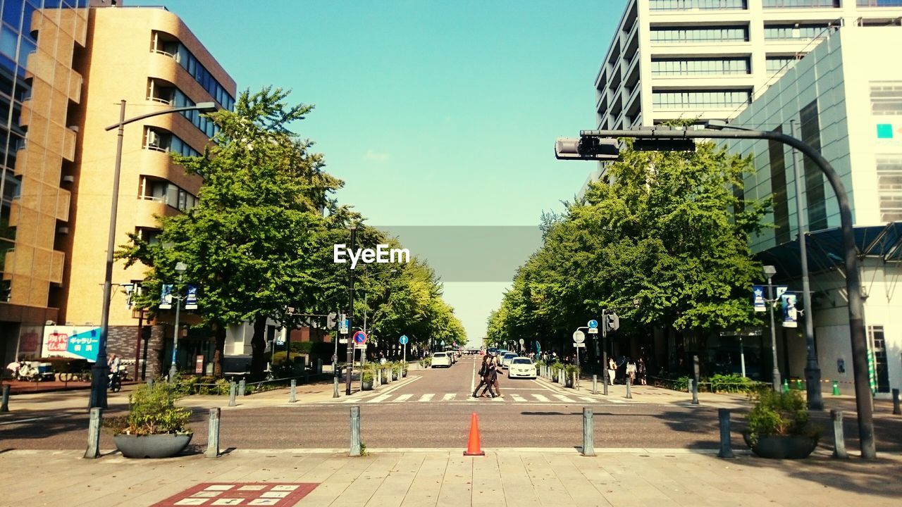 City street amidst buildings against clear sky