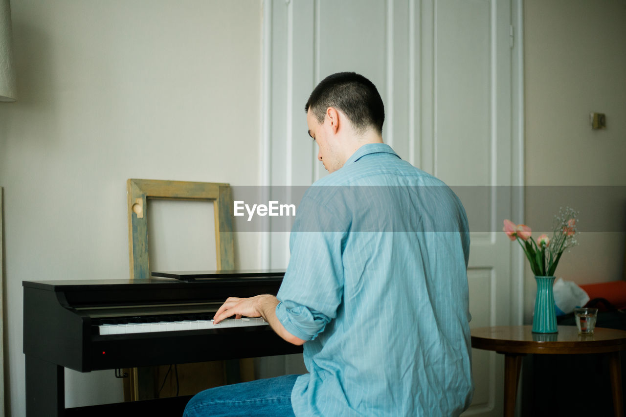 A young man playing piano