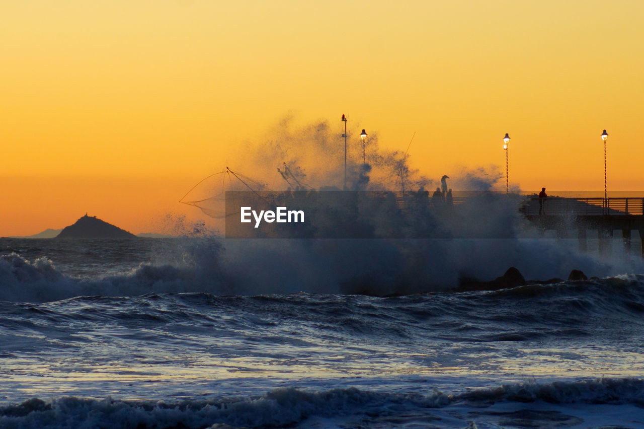 Scenic view of sea against clear sky during sunset