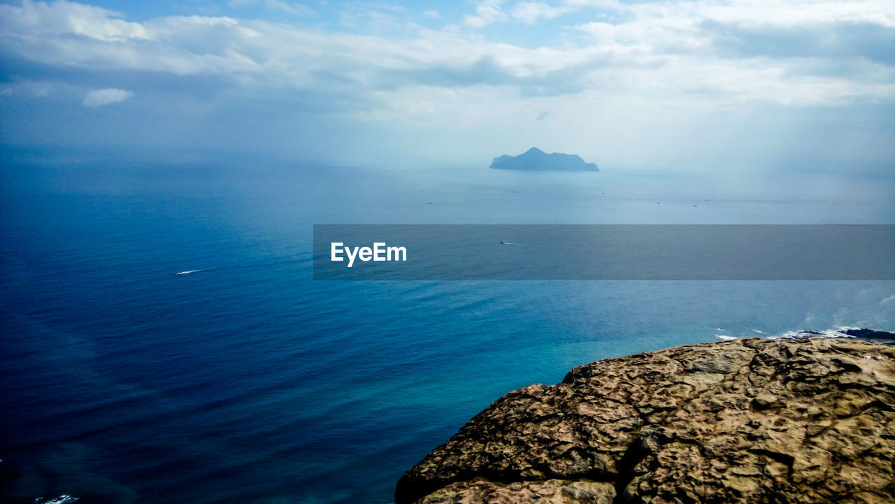 Scenic view of sea against blue sky