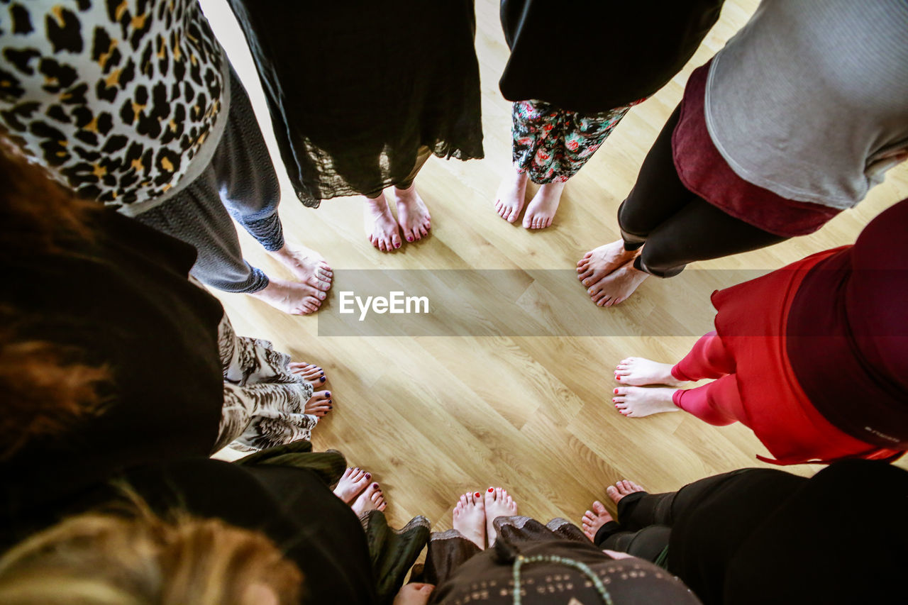 HIGH ANGLE VIEW OF PEOPLE STANDING ON THE FLOOR