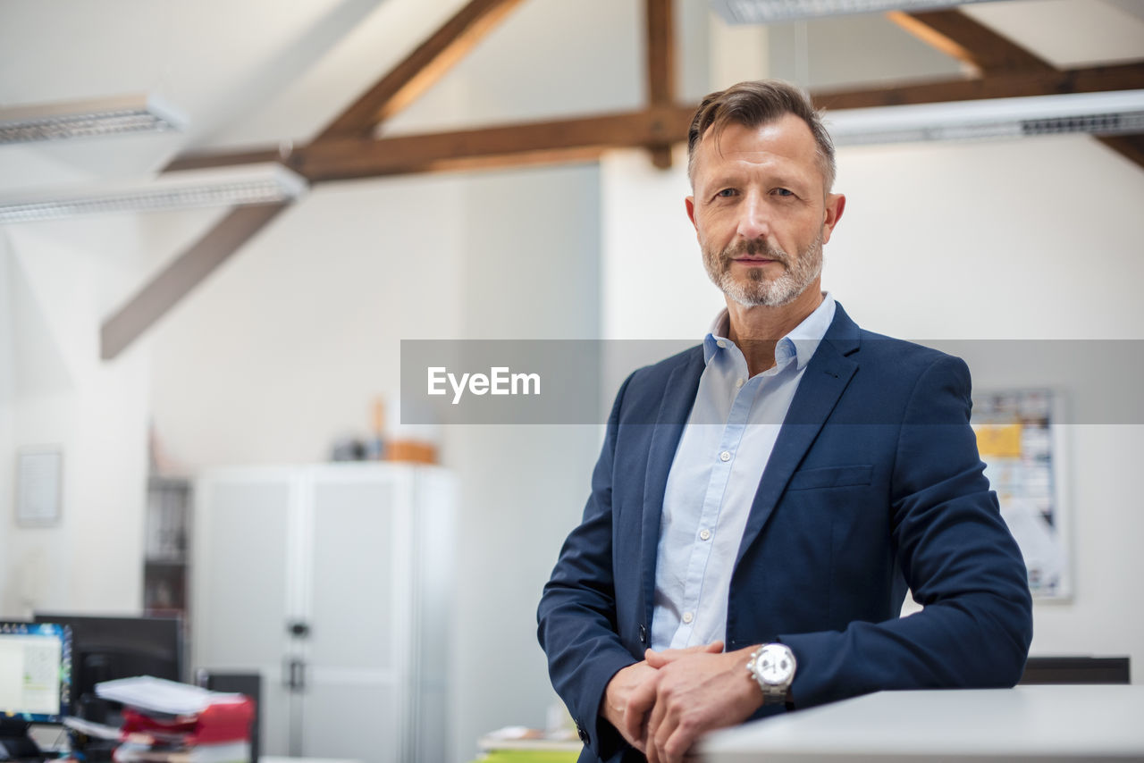 Portrait of confident mature businessman in office