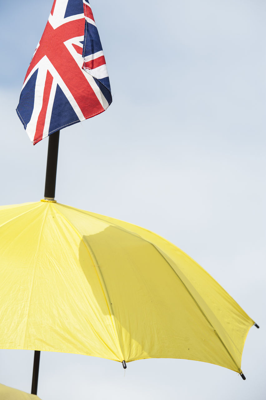 British flag on yellow parasol against clear sky