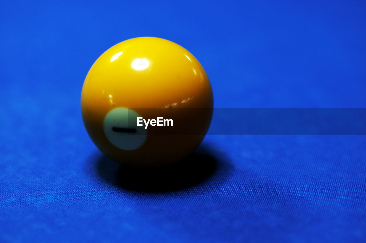 Close-up of yellow ball on pool table