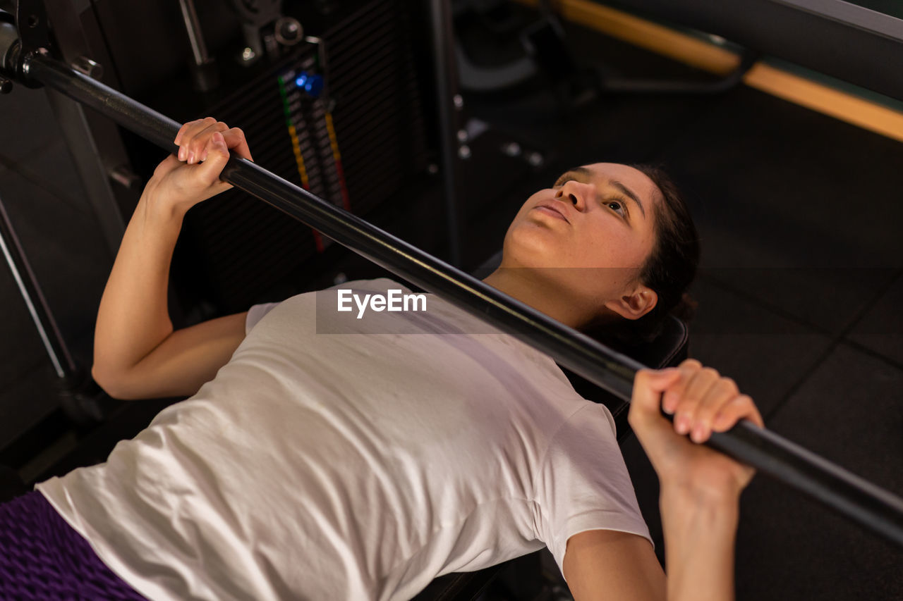 portrait of young woman exercising in gym