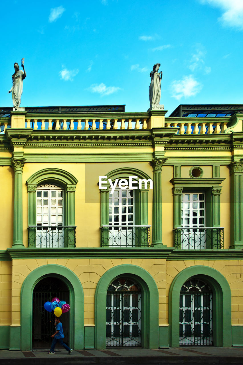 building exterior, architecture, built structure, sky, window, arch, day, facade, architectural column, outdoors, cloud - sky, low angle view, statue, no people