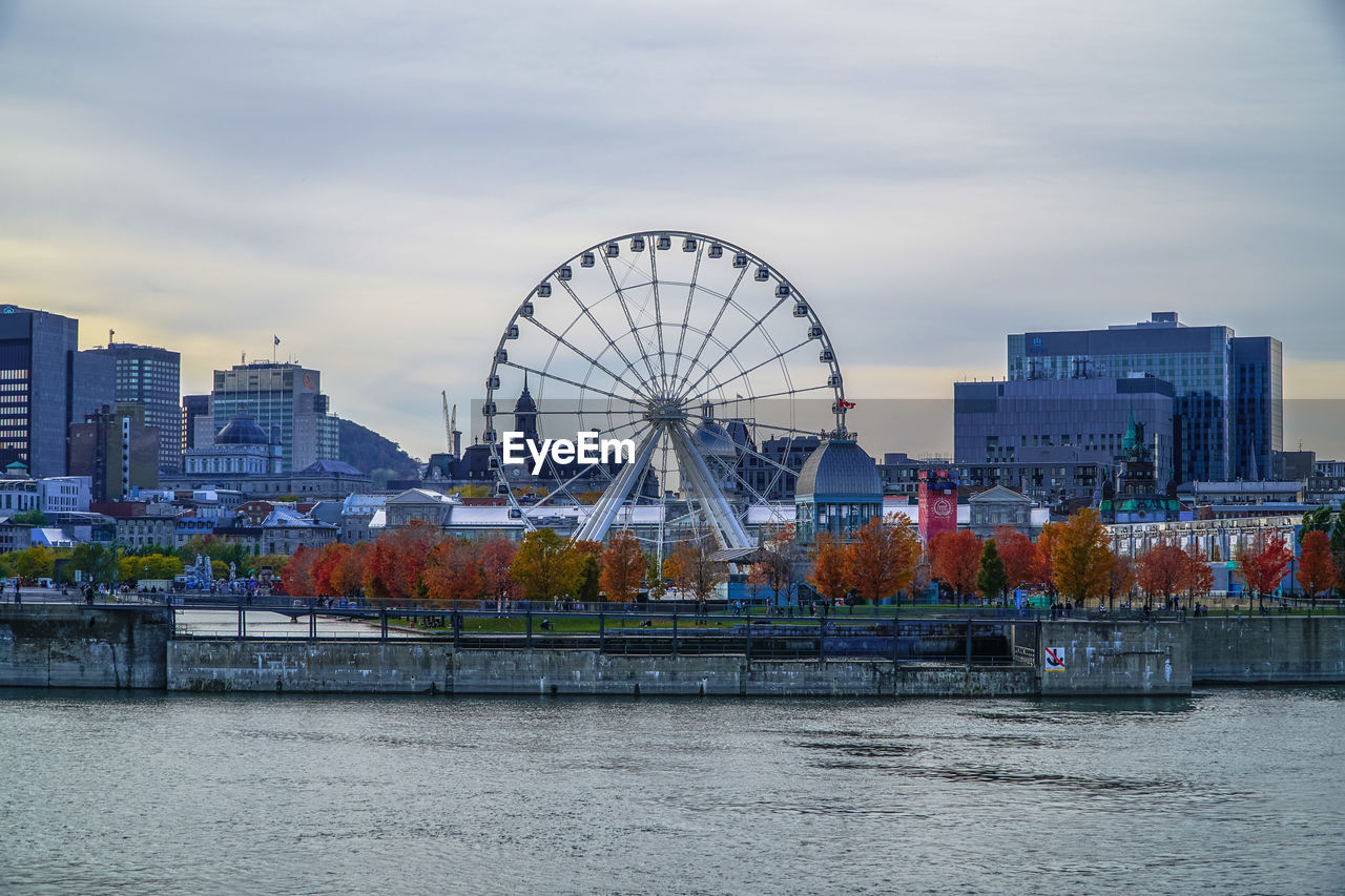 Ferris wheel in city against sky