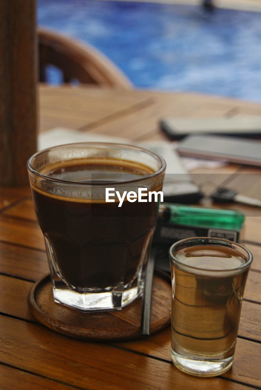 CLOSE-UP OF COFFEE ON TABLE IN GLASS