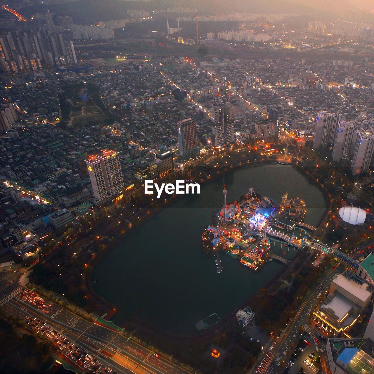 HIGH ANGLE VIEW OF ILLUMINATED BUILDINGS IN CITY