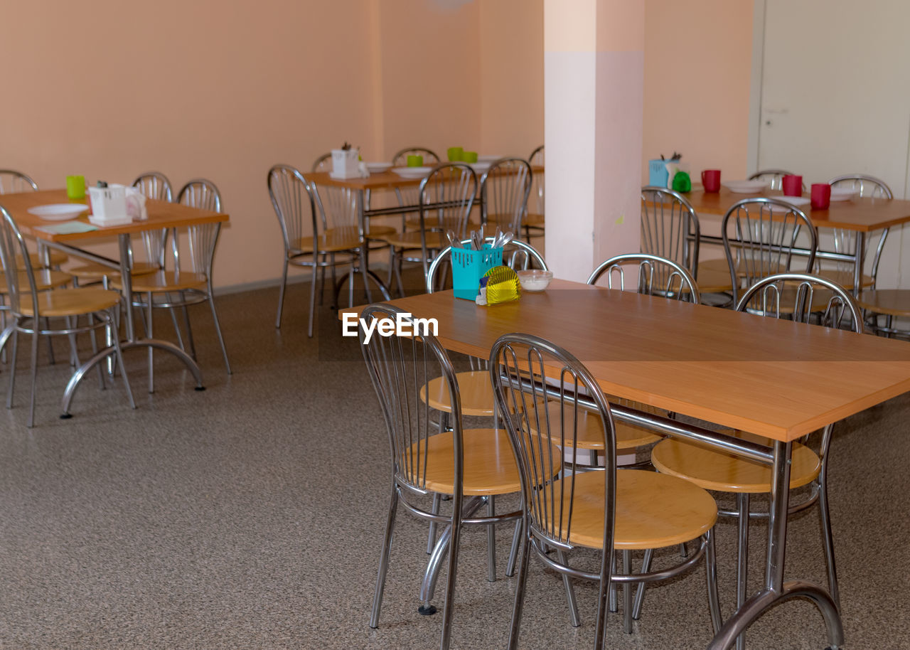 School kitchen canteen, metal table and chair legs, canteen equipment, catering establishment