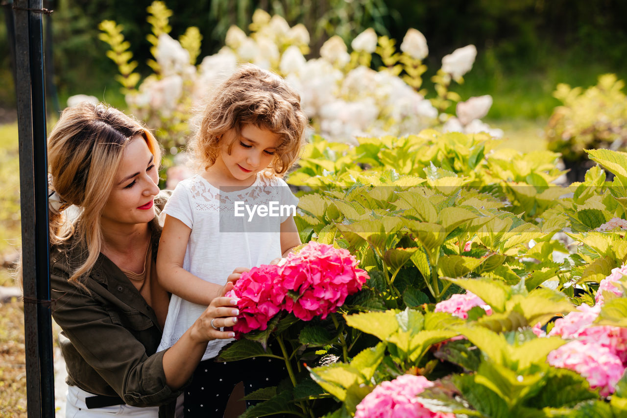 Mother and daughter on flowering plants