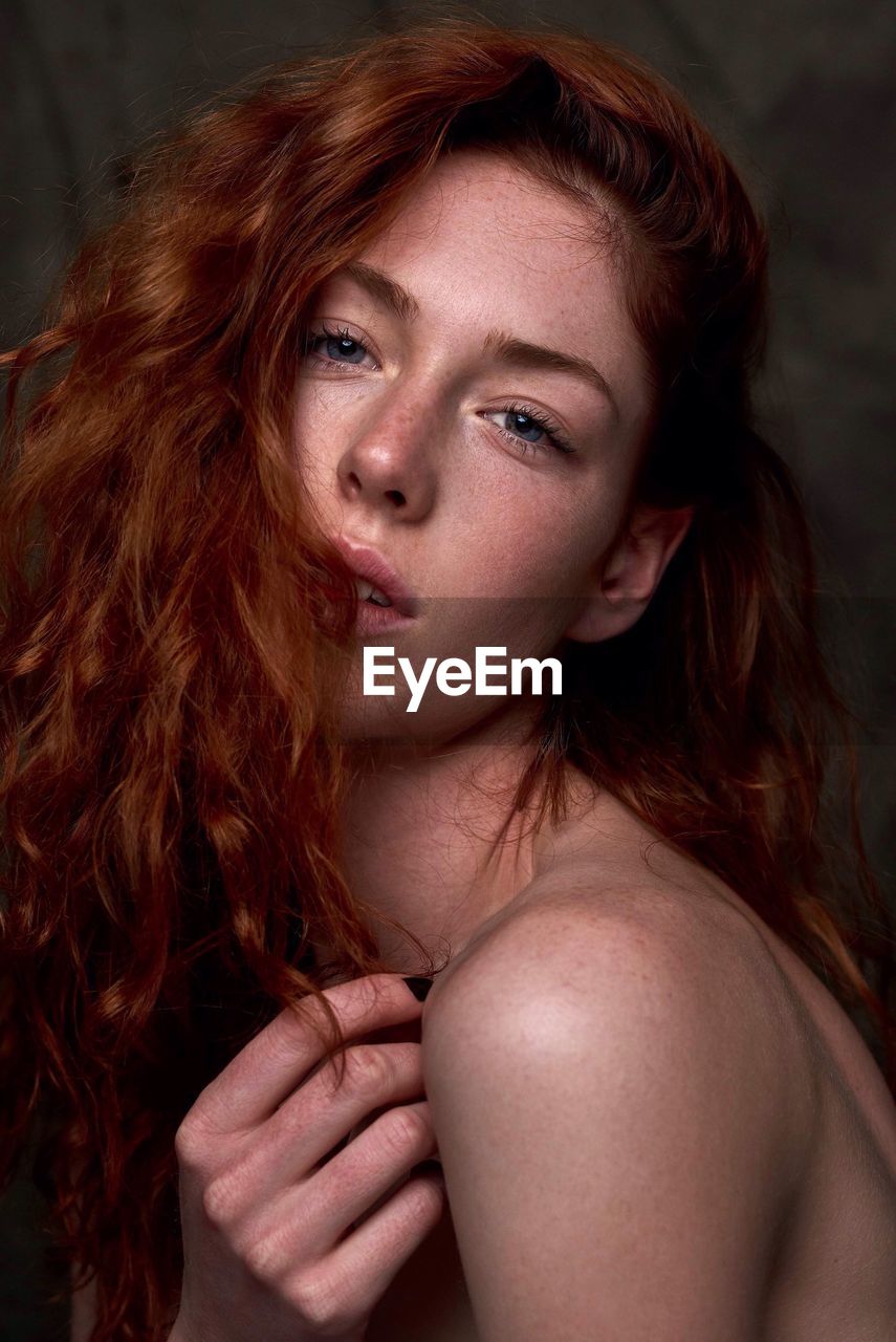 Close-up portrait of beautiful young woman with redhead