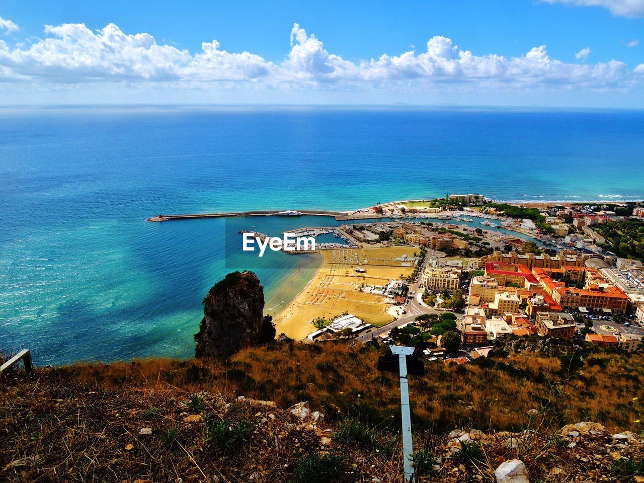 High angle view of sea and buildings against sky