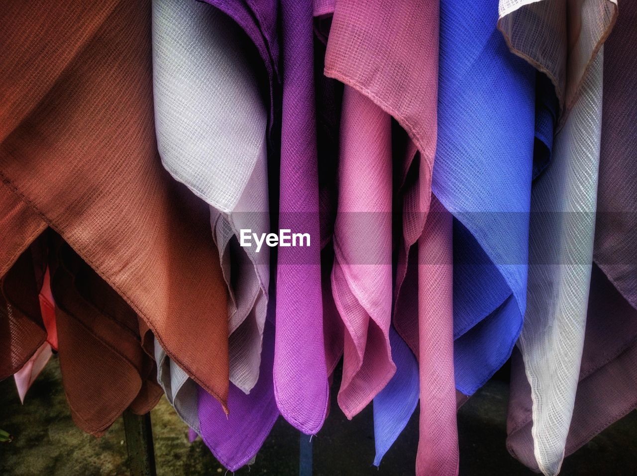 Close-up of multi colored clothes hanging for sale 