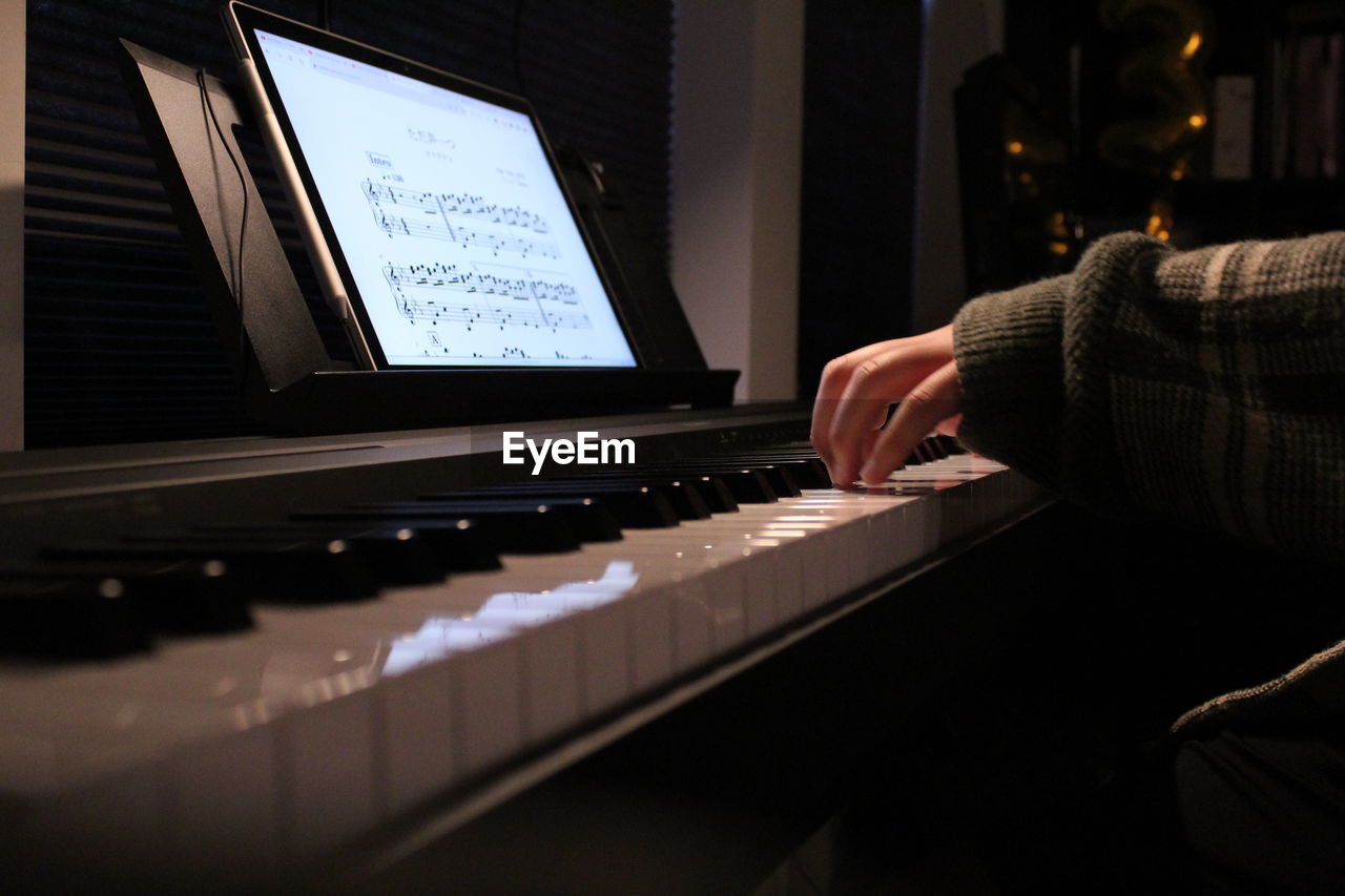 cropped image of man playing piano