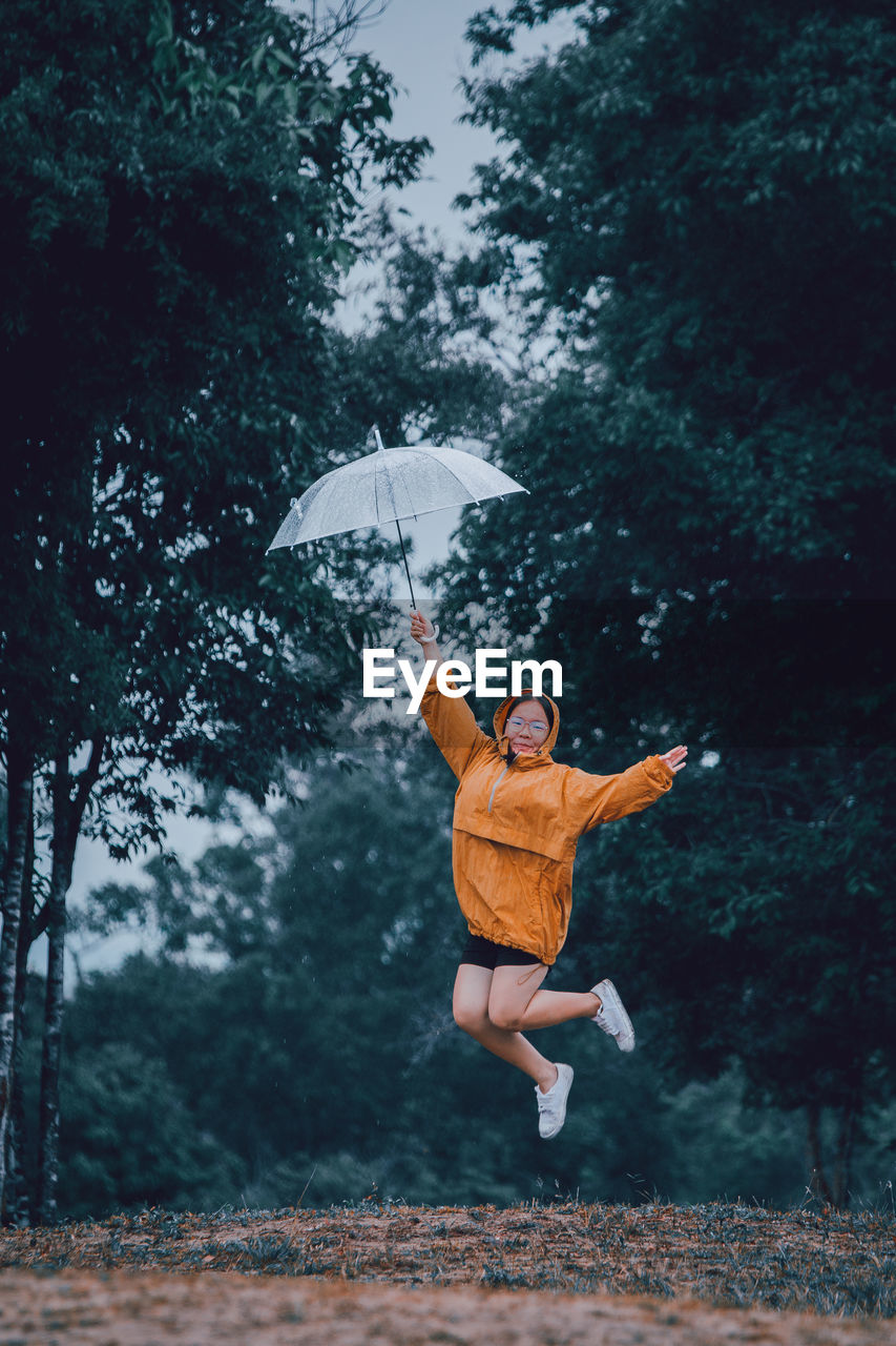 Girl jumping in rain