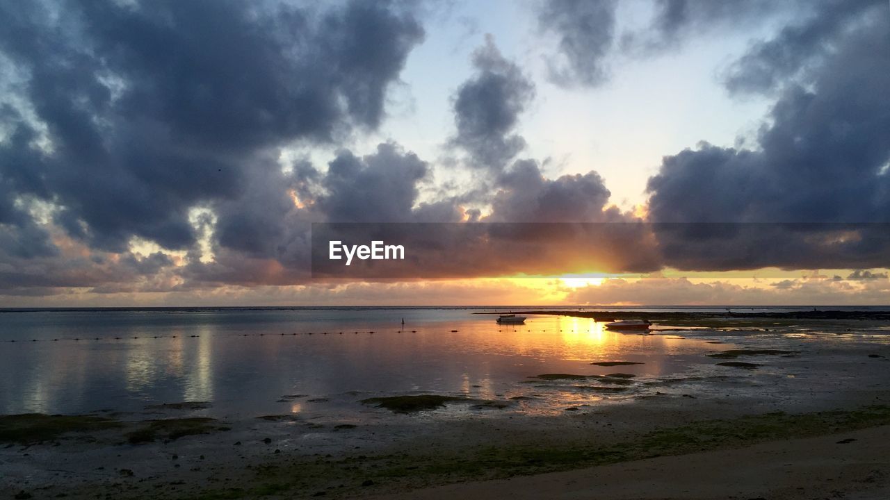 Scenic view of sea against cloudy sky