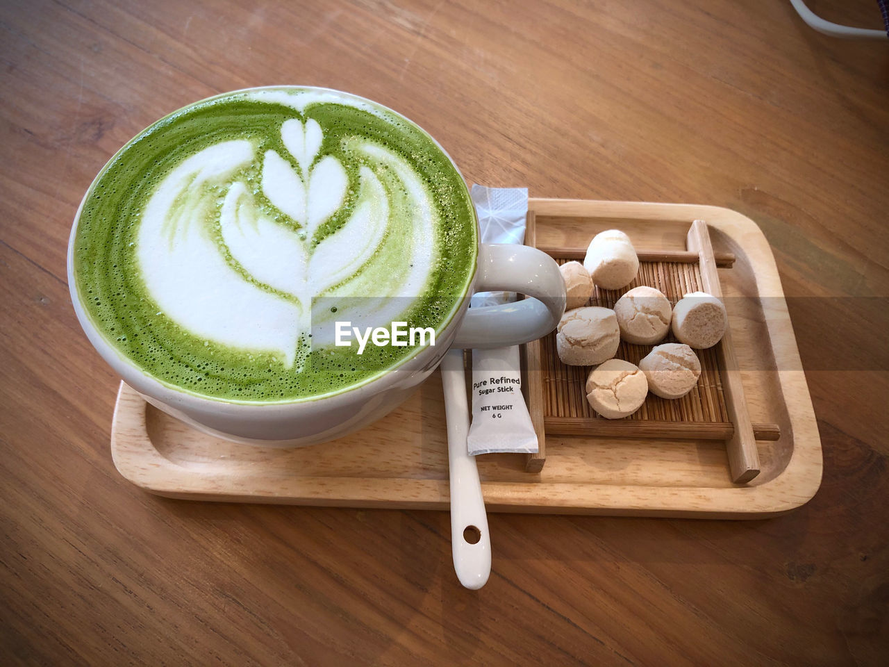 food and drink, food, drink, refreshment, wood, healthy eating, indoors, freshness, produce, cup, hot drink, still life, wellbeing, coffee, green, no people, high angle view, mug, frothy drink, matcha tea, table, kitchen utensil, crockery, latte, coffee cup, cappuccino, directly above, studio shot, dairy
