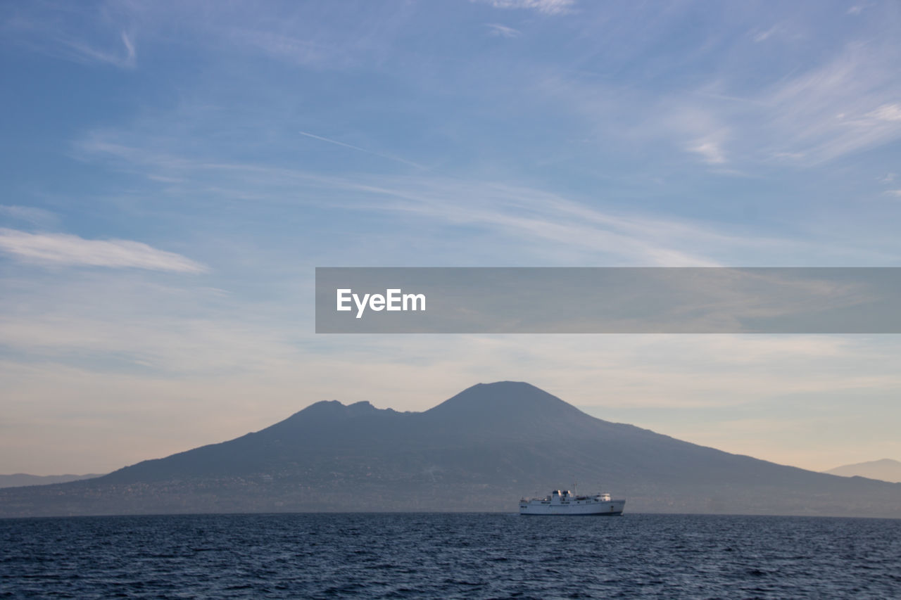 Sailboat in sea against vesuvio and  sky