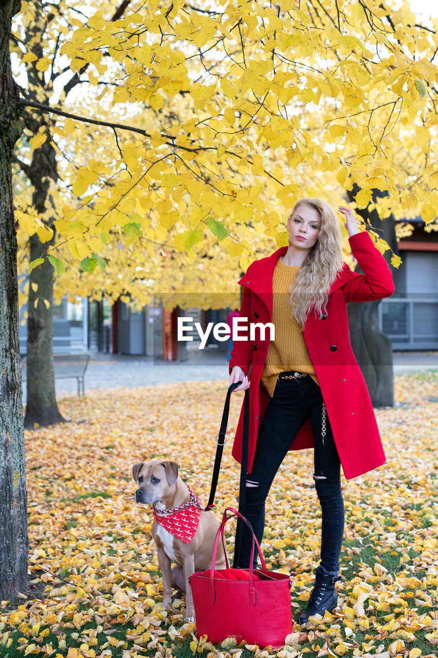 Portrait of woman with dog during autumn