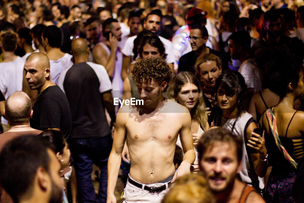 HIGH ANGLE VIEW OF PEOPLE LOOKING AT GROUP OF CROWD