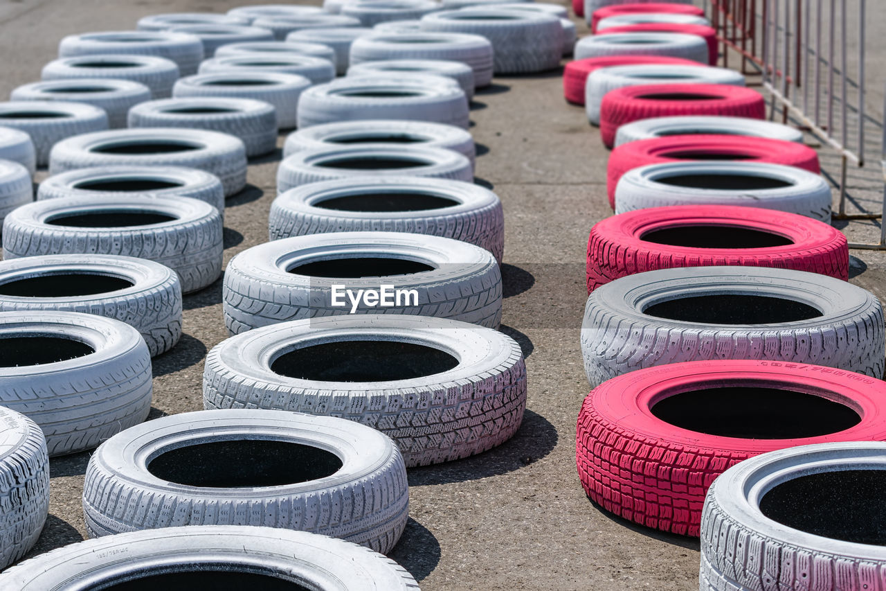 Car tires lying on the asphalt of a racing track for safety