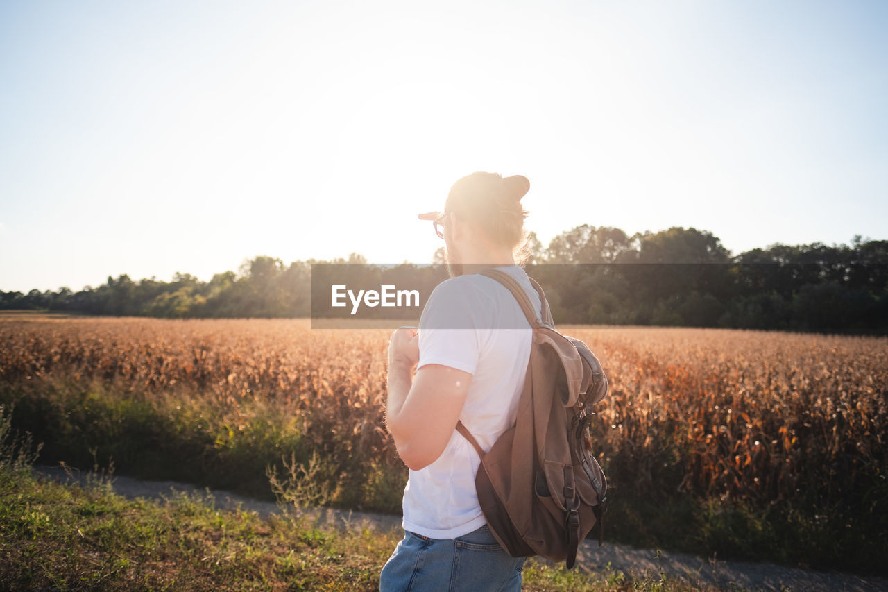 Man standing on land against clear sky