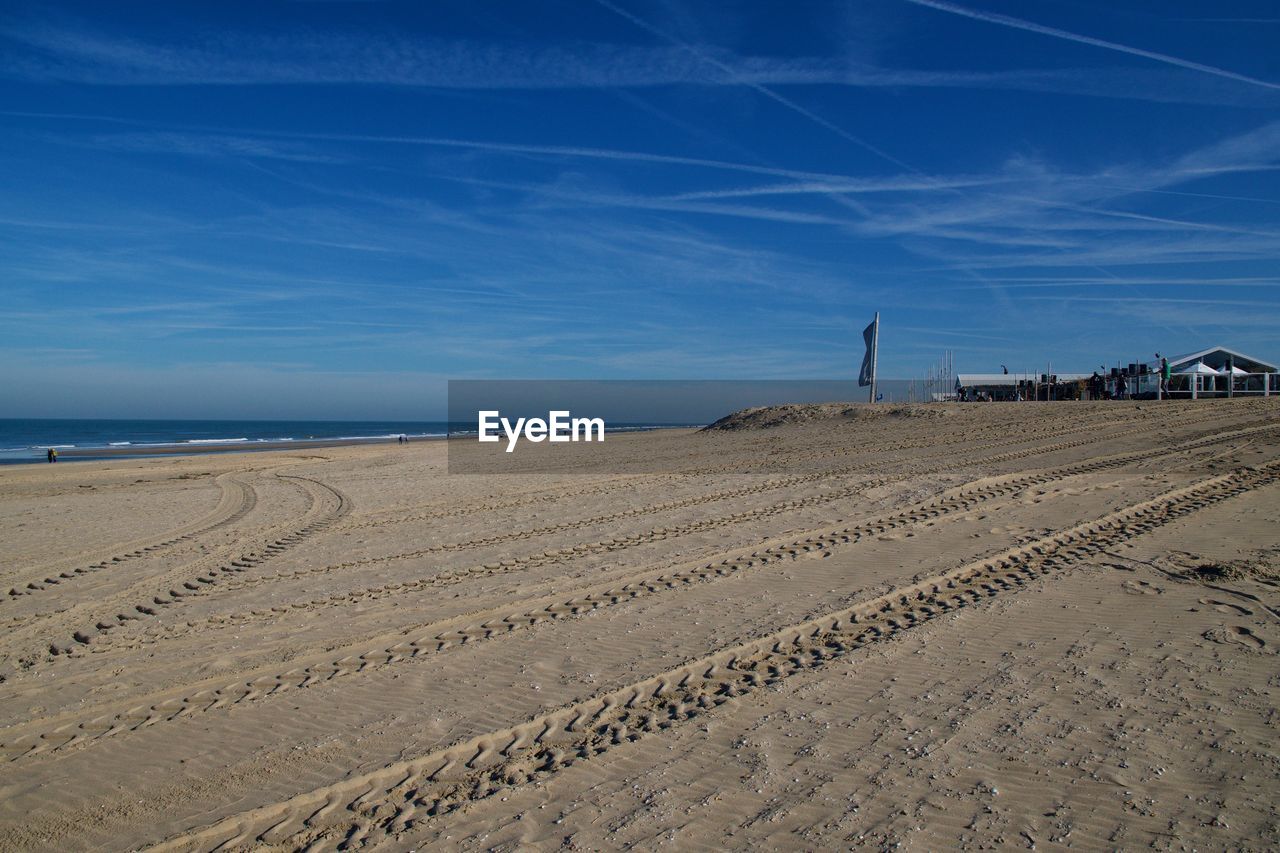 Scenic view of beach against blue sky